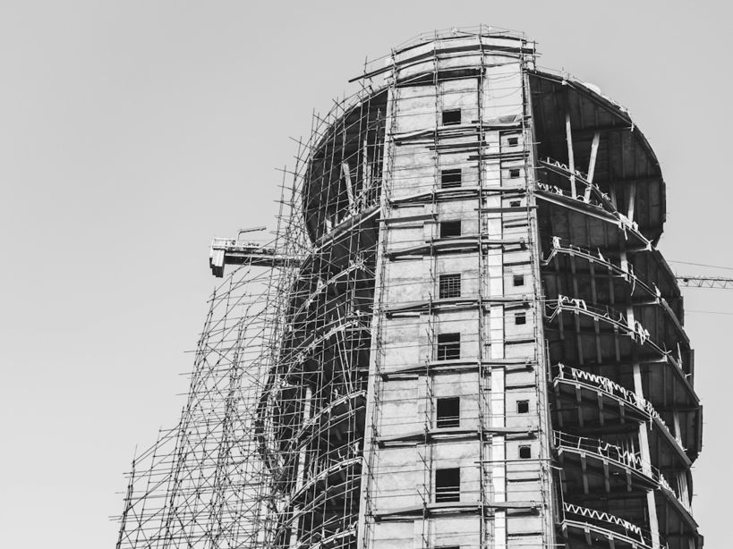 grayscale photo of construction of high-rise building